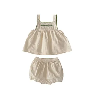 Infant girl beige cotton set featuring floral embroidery top and matching pumpkin shorts