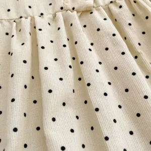 Infant velvet romper with polka dot pattern and ribbed corduroy fabric details