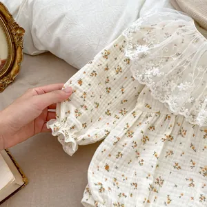 Detail of baby floral romper featuring wide lace collar and vintage floral cotton fabric