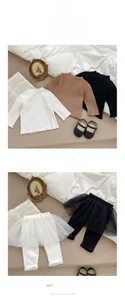 Detailed view of ribbed long sleeve tops and tulle tutu leggings in neutral tones