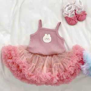 Close-up of pink baby girl tank top with crochet rabbit patch and fluffy mesh tutu skirt
