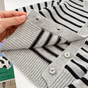 Detail of grey striped knit cardigan with marbled buttons and ribbed cuffs for baby boys