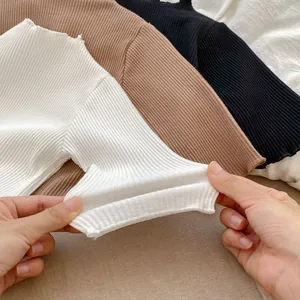 Close-up of ribbed elastic knit fabric showing texture on toddler girl ruffled outfit