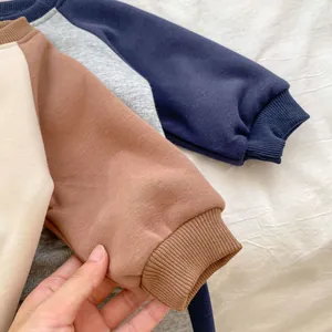 Close-up of ribbed cuffs and necklines on four different colors of toddler fleece sweatshirts