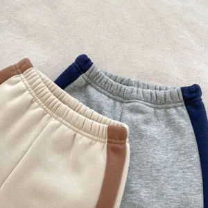 Detail of elastic waistbands and side stripes on children's fleece jogger pants