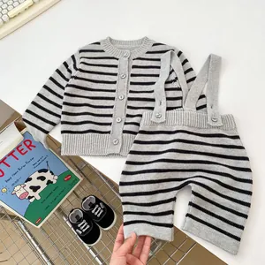 Knitted two-piece baby set featuring grey striped cardigan and matching suspender pants