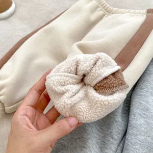 Close-up of children's fleece jogger pants showing warm sherpa lining and cuff detail