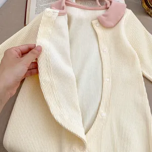 Cute cream ribbed baby bodysuit with pink Peter Pan collar and snap button closure