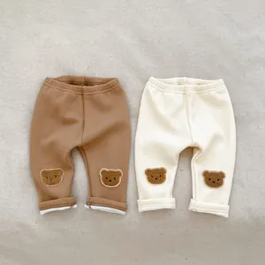 Detail of baby ribbed leggings featuring cute bear embroidery and elastic high waistband