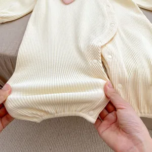 Detailed macro view of the elastic ribbed knit fabric on infant long-sleeve bodysuit