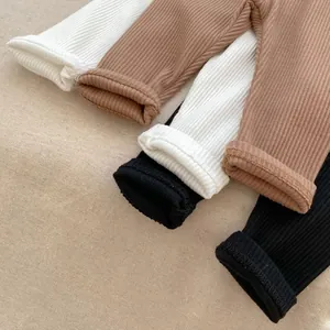 Detail of ribbed knit baby pants showing fine stitching and soft fabric texture