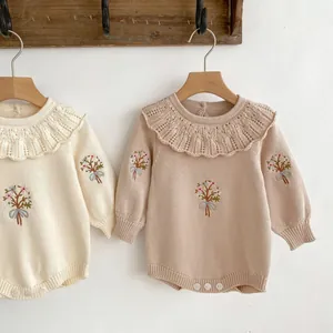 Detailed embroidery and lace collar on infant knit rompers in cream and beige colors