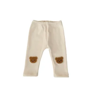 Infant ribbed thermal pants in cream white featuring cute brown bear knee patches
