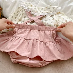 Detail of baby girl floral top with lace collar and elastic waist pink bloomers set
