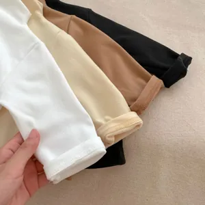 Detail of soft ribbed cuffs on kids thermal base layers in four neutral colors
