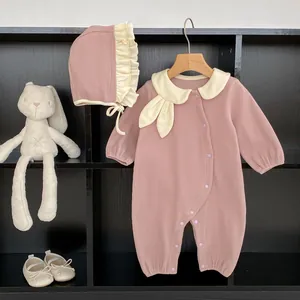 Detail view of pink ribbed cotton baby romper with large collar and matching ruffle hat