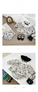 Detailed view of floral baby girl set featuring ruffled lace collar and bow-knot details