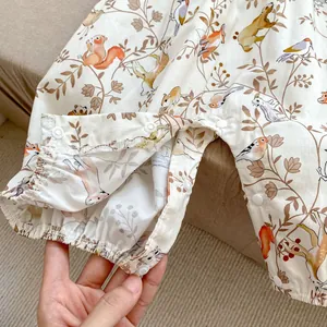 Detail of snap button closure and elastic cuffs on baby animal print bodysuit
