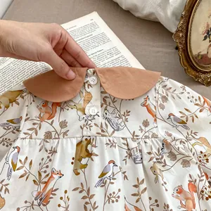 Detail of baby onesie featuring forest animal prints and a cute Peter Pan collar