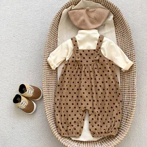 Flat lay of baby corduroy polka dot overalls set with matching beret and shoes