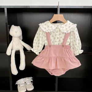 Floral baby girl set featuring long sleeve shirt with lace collar and suspender skirt