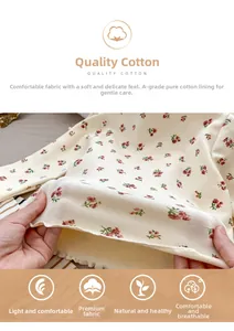 Detailed view of soft Class A pure cotton fabric with floral pattern and wavy hemline