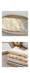 Detailed view of kids ribbed long sleeve shirts with floral prints and ruffle trim