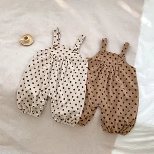 Baby corduroy polka dot jumpsuit set with adjustable straps and natural wooden buttons