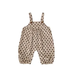 Infant polka dot corduroy romper with wooden buttons and snap closure for spring