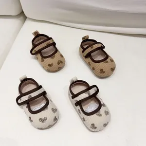 Close-up of corduroy baby Mary Jane shoes with heart pattern and double straps