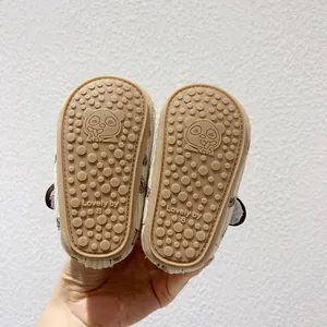 Detailed view of baby walking shoe sole with non-slip panda pattern and rubber grip