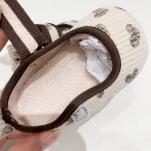 Corduroy baby walking shoes with brown heart patterns and soft lining closeup view