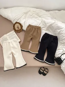 Detailed close-up of girls ribbed flare pants with contrast wavy lace trim and elastic waist