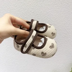 Detail of baby Mary Jane shoes with heart pattern, corduroy fabric and velcro strap