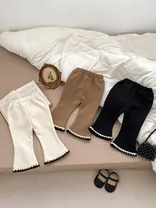 Detailed view of ribbed knit flare leggings for girls with ruffled hem in various colors