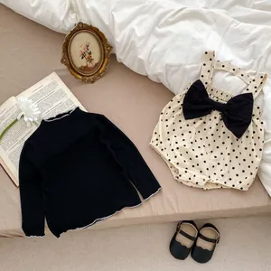 Baby girl clothing set with black long sleeve top and polka dot suspender romper