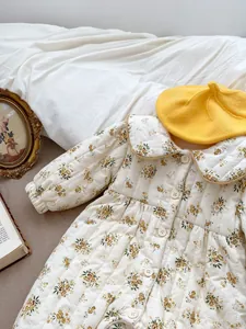 Close-up of winter baby floral quilted romper with Peter Pan collar and button closure