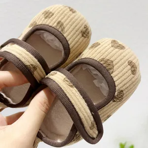 Detail of infant corduroy Mary Jane shoes with heart pattern and soft non-slip soles