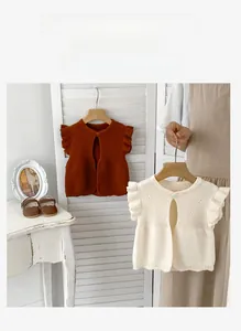 Detail of A-grade cotton knit baby vest featuring ruffle sleeves and single button closure
