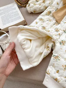 Detail of baby floral quilted romper with thick fleece lining and ribbed cuffs