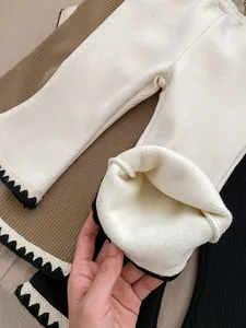 Detail showing thick white fleece lining and ribbed fabric of girl's winter flare pants