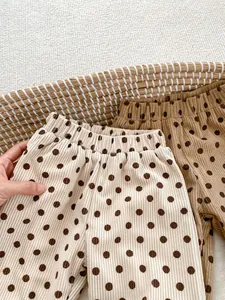 Close-up of children's corduroy polka dot pants with elastic waistband texture