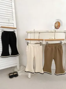 Three pairs of girls' ribbed knit flare pants with delicate scalloped lace trim details