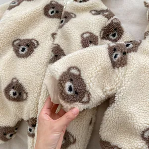 Detail of baby hooded fleece romper with all-over bear print and ribbed cuffs