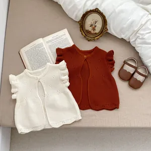 Knitted infant vest sweater with ruffle sleeves and wooden button in cream and brick red