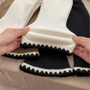 Thick fleece-lined ribbed flare pants for girls featuring wavy crochet edges and high elasticity