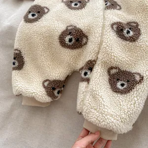 Close-up of baby sherpa romper featuring warm fleece texture and bear print pattern