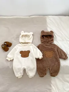 Detailed view of plush baby bear rompers with fleece texture and matching ear hats