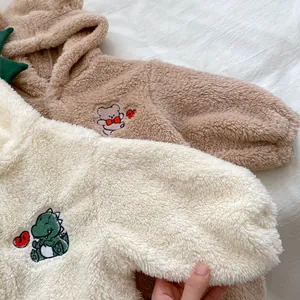Close-up of baby fleece hooded jumpsuit showing soft coral velvet texture and cute embroidery