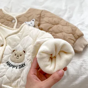 Detail of baby quilted jacket lining featuring plush fleece and cute bear embroidery